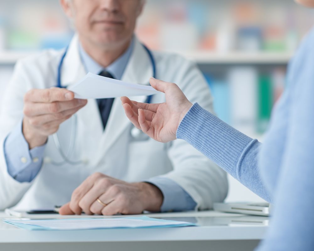doctor-handing-prescription-to-patient-in-office-2026-03-09-08-13-15-utc (1)