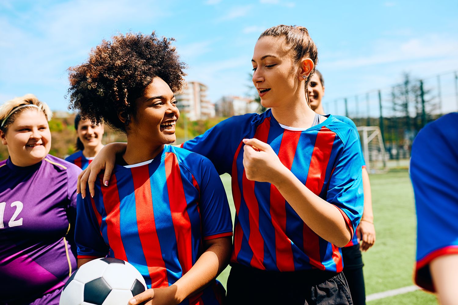 smiling-women-soccer-teammates-in-striped-jerseys-2026-01-06-10-27-37-utc (1)